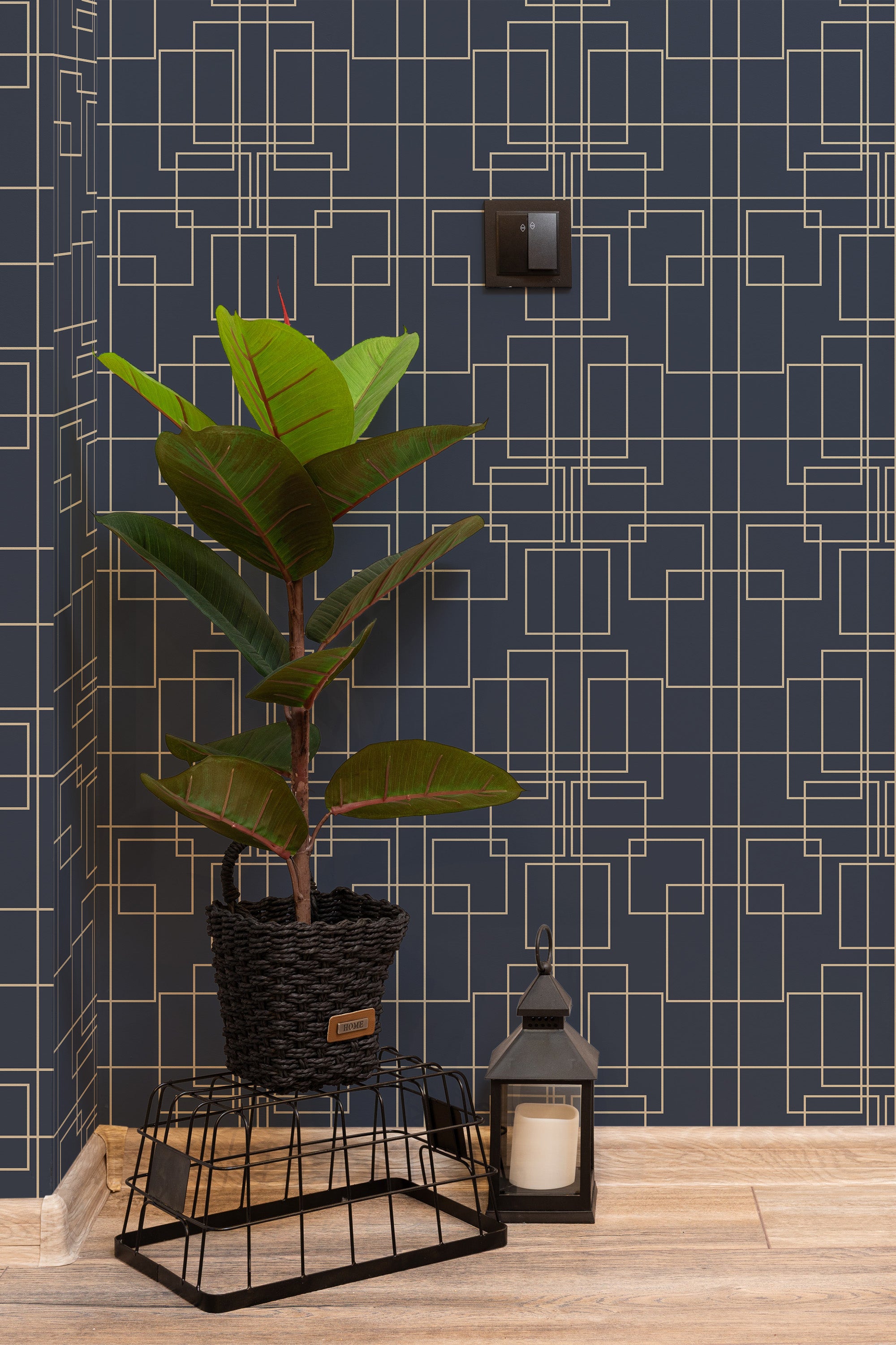 Self-adhesive wallpaper with a Great Gatsby-inspired geometric pattern in gold on a navy blue background, enhancing an elegant room corner with a potted plant and decorative lantern.