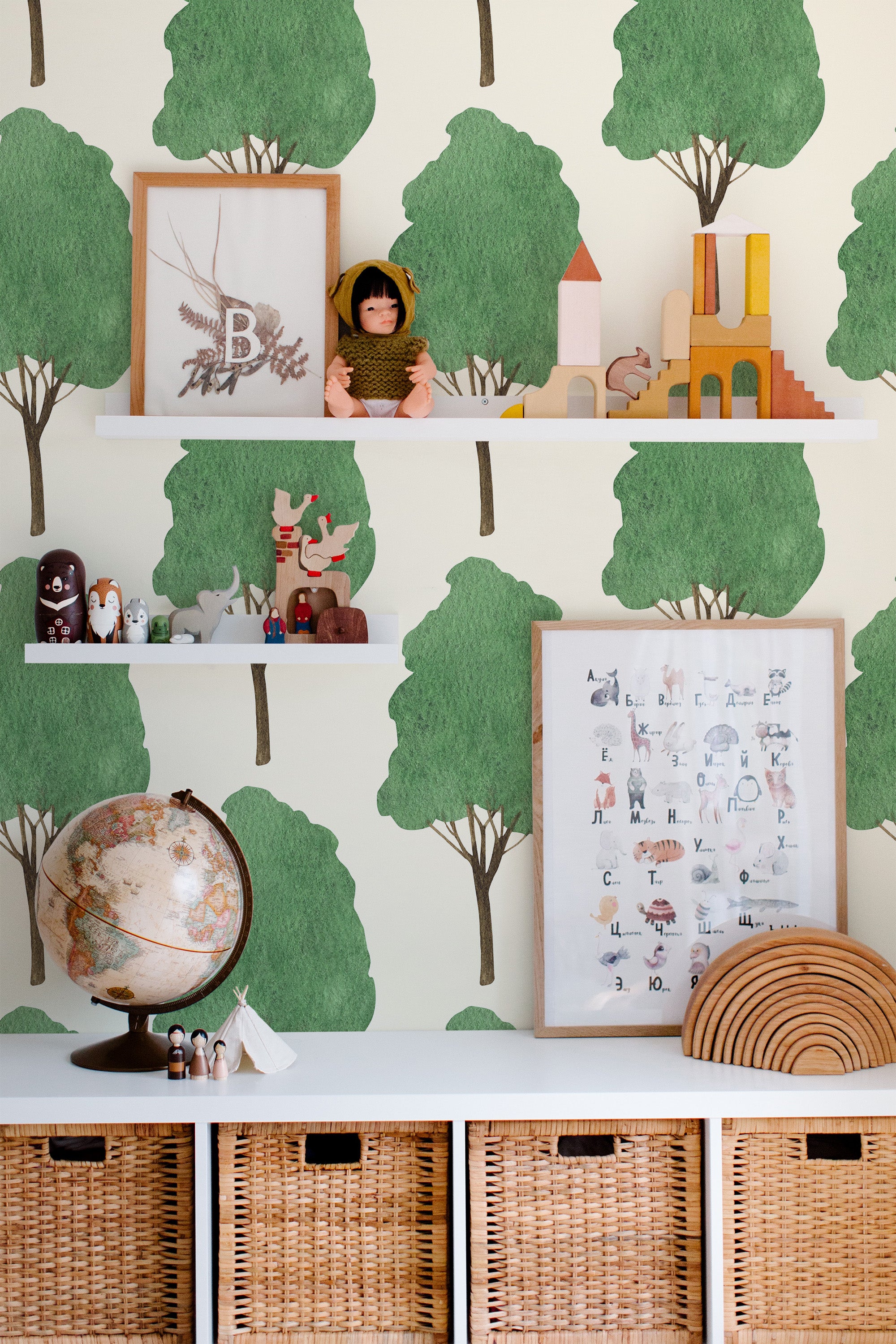 Self-adhesive Watercolor forest wallpaper with stylized tree patterns, accompanied by decorative shelves and children's toys.
