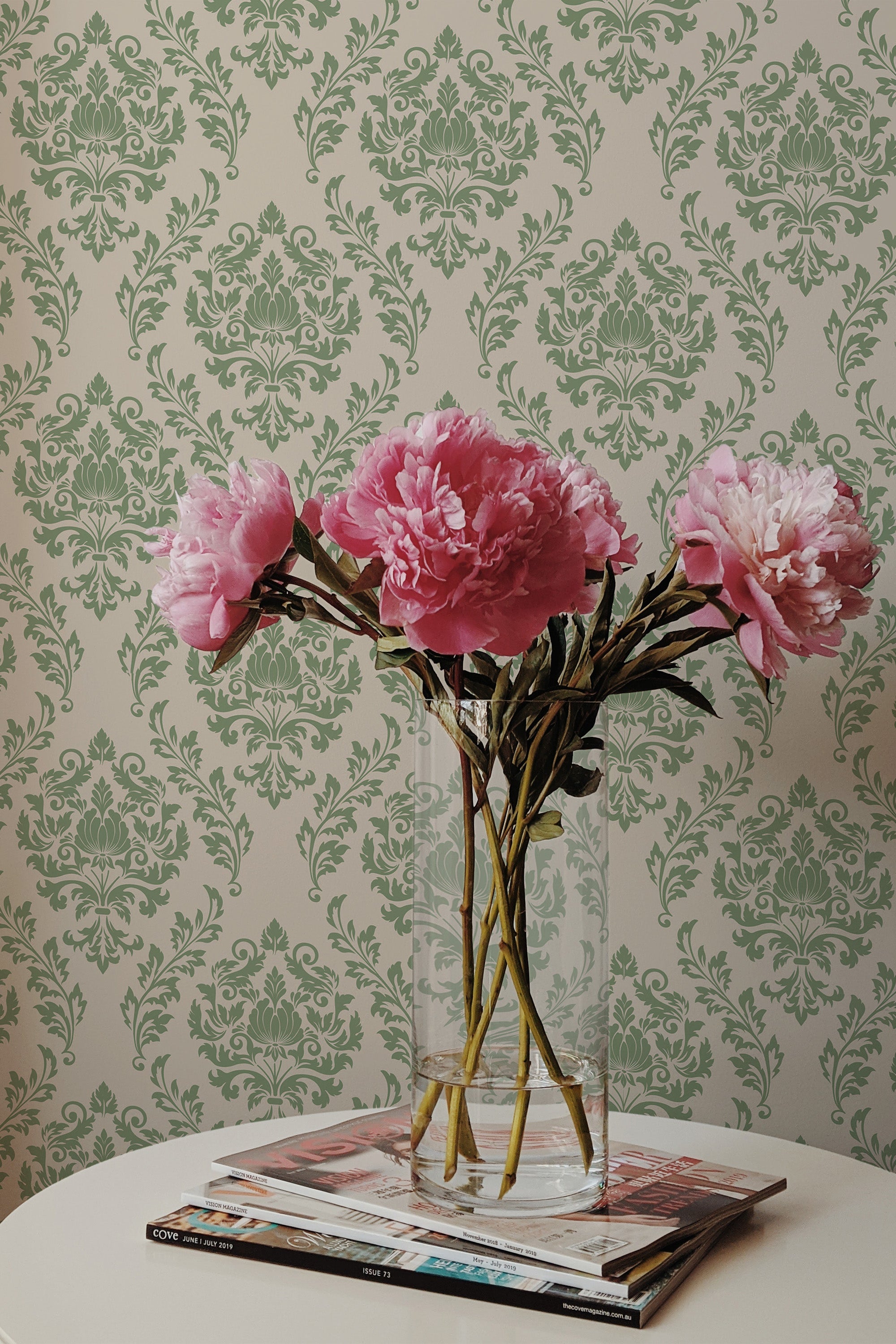 Self-adhesive Green damask wallpaper with intricate floral patterns on a light background, creating a classic and elegant look in the room.