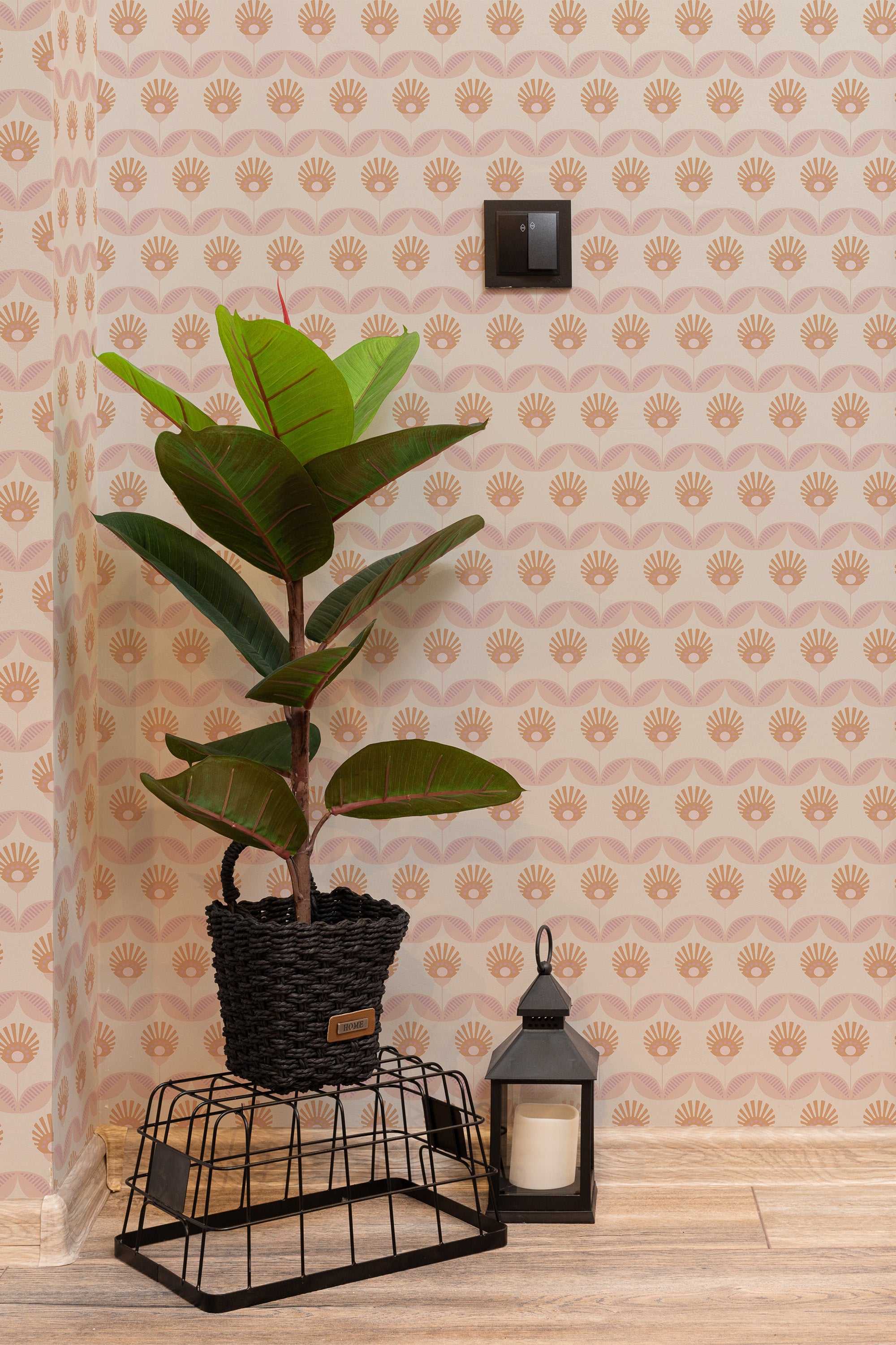 Self-adhesive wallpaper with a geometric retro flower pattern in shades of brown and beige, accenting a room with a potted plant and decorative items.