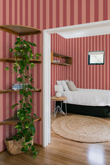 bedroom cozy interior green plants round carpet pink and red stripes peel & stick wallpaper