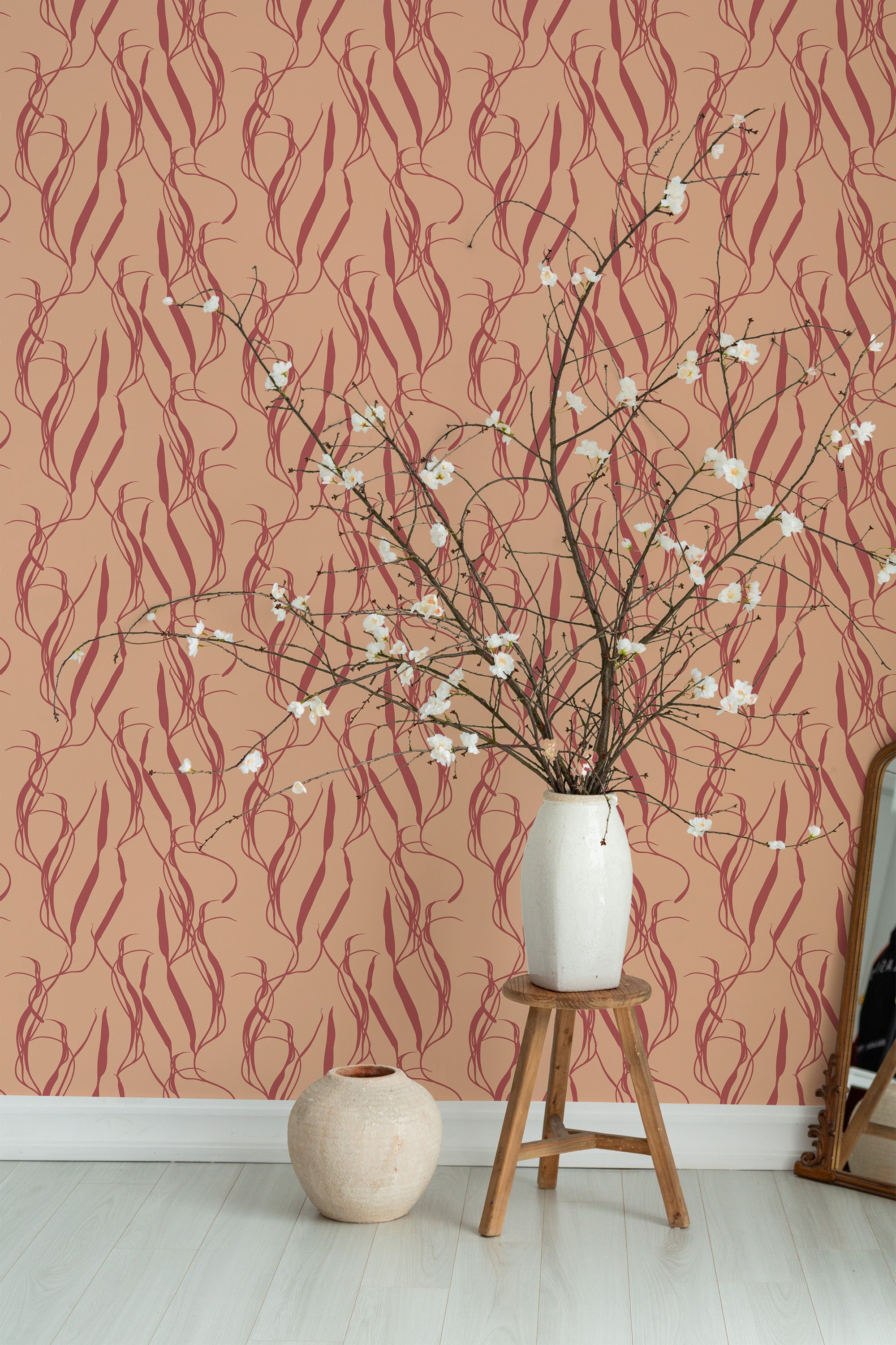 Self-adhesive wallpaper with an aesthetic plant pattern of intertwined vines and leaves on a soft peach background, complementing a modern room decor.