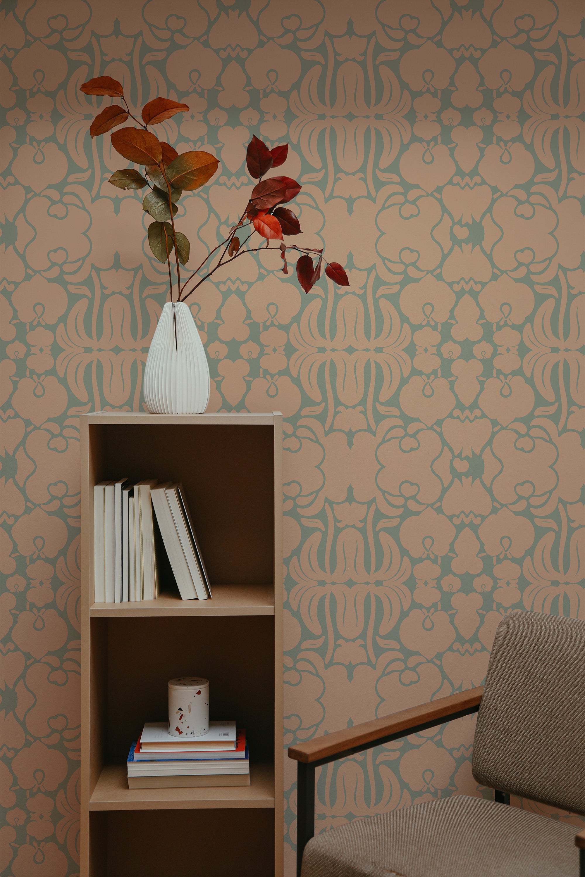 Self-adhesive Peach and Green Victorian wallpaper with ornate floral and leaf patterns in a room with a bookshelf and armchair.
