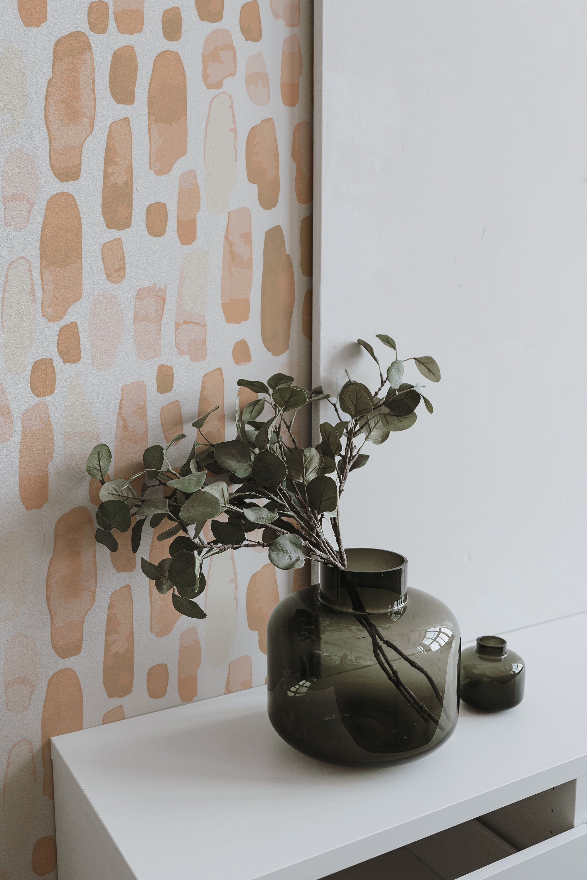 Self-adhesive Peachy Watercolor Drops wallpaper with abstract shapes in varying shades of peach and tan on a white background, adding a modern artistic touch to the room decor.