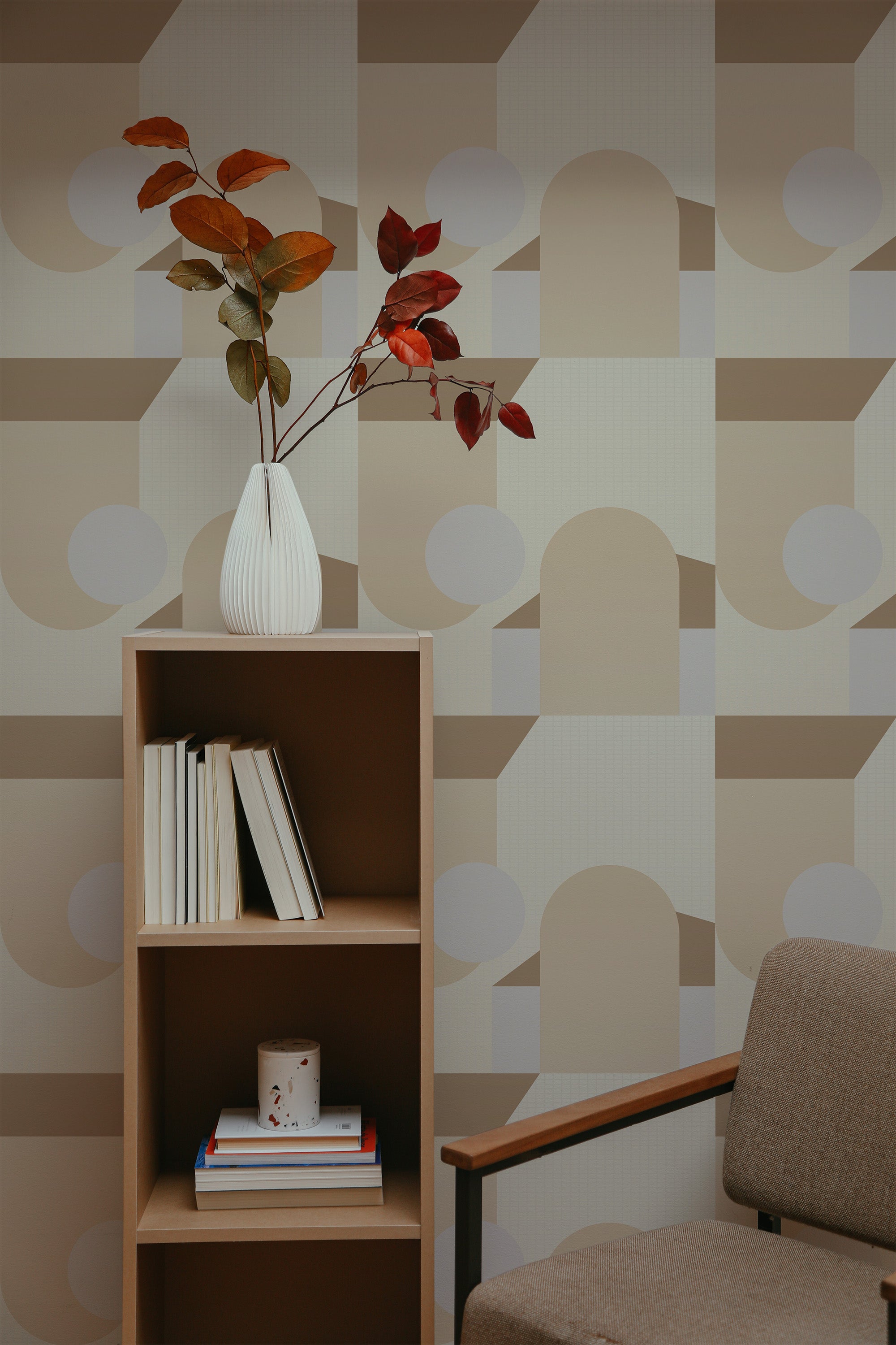 Self-adhesive Aesthetic boho geometric wallpaper with neutral tones and circular and semicircular patterns on a room wall, complementing a wooden bookshelf and a vase with leaves.