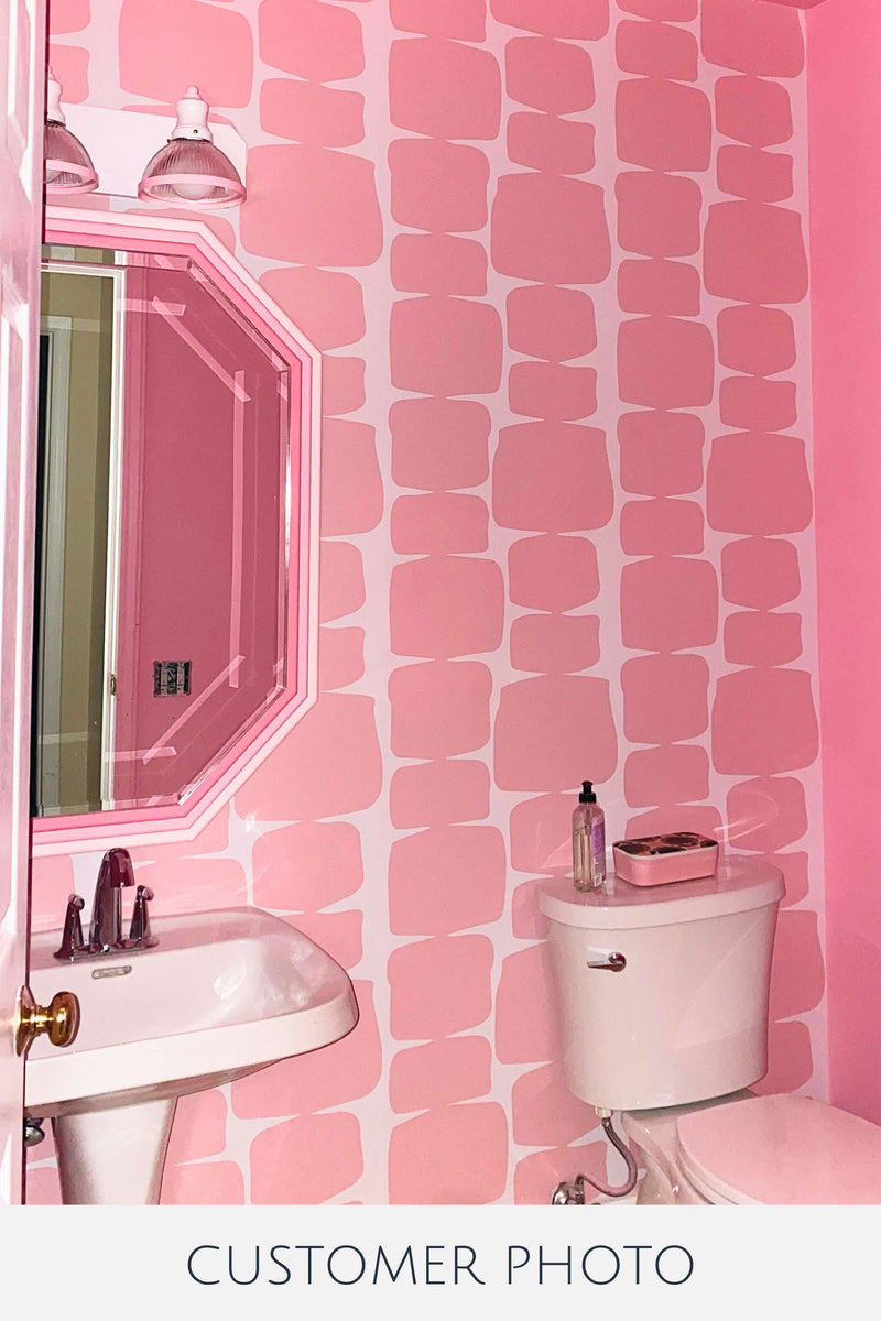 Pink bathroom makeover with retro peel and stick wallpaper